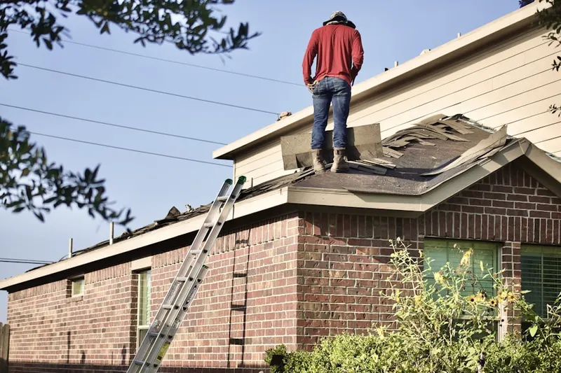 Professional roofer working on a residential roof in Amber Hills